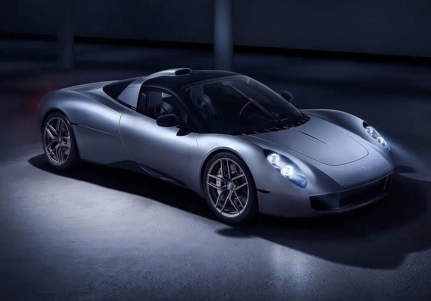 The electric sports car is shown in a dark room